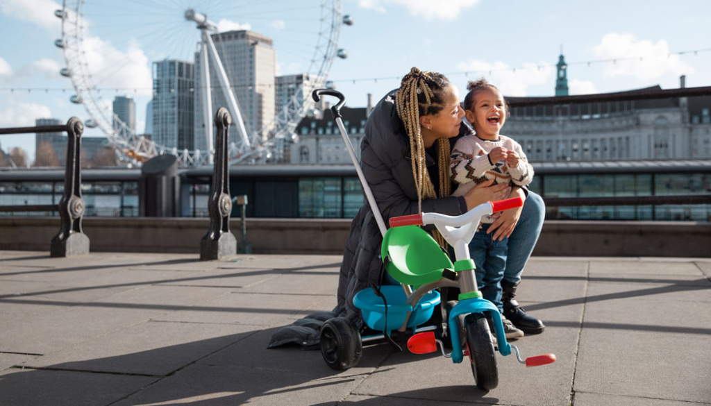happy-mother-kid-with-tricycle-full-shot1050x600.jpg